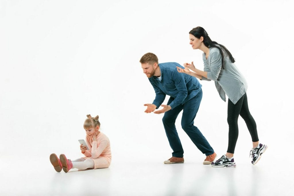 angry parents scolding their daughter home studio shot emotional family human emotions childhood problems conflict domestic life relationship concept